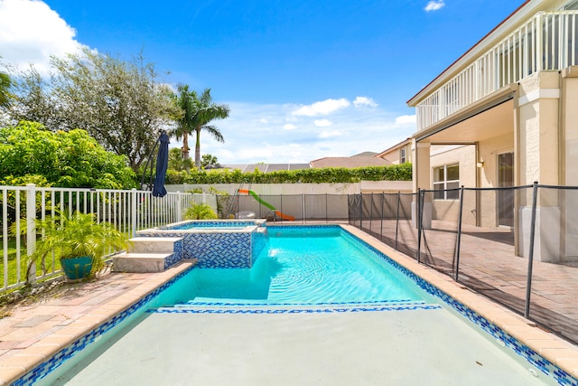 view of pool featuring an in ground hot tub and a patio area