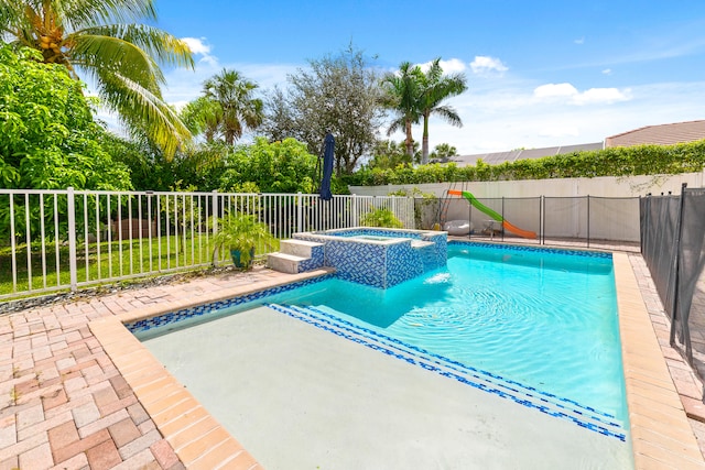 view of pool featuring an in ground hot tub and a patio area