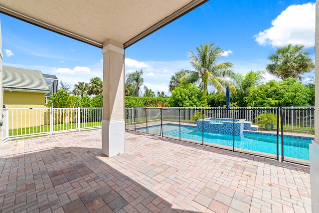 view of swimming pool featuring a patio and an in ground hot tub