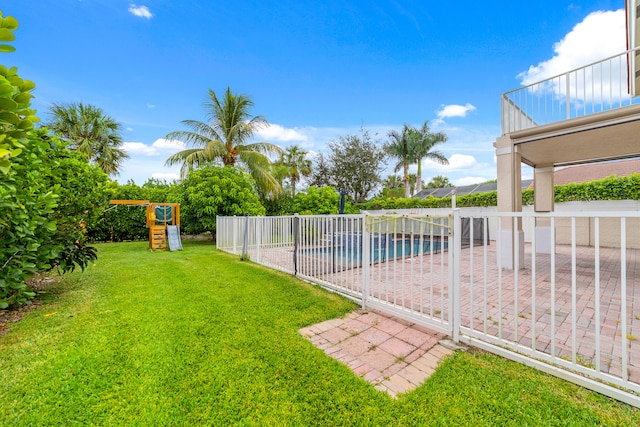 view of yard featuring a fenced in pool and a balcony