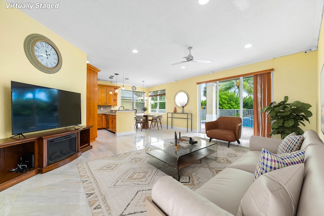 living room featuring a healthy amount of sunlight and ceiling fan