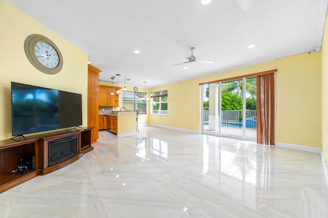 living room with a textured ceiling and ceiling fan