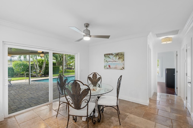 dining space with crown molding and ceiling fan