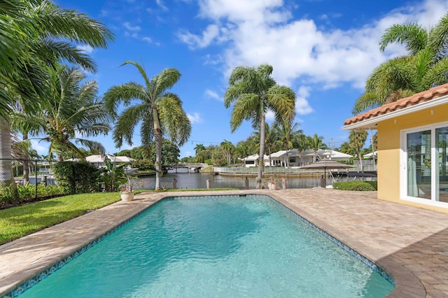 view of pool with a water view and a patio