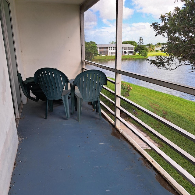 unfurnished sunroom with a water view