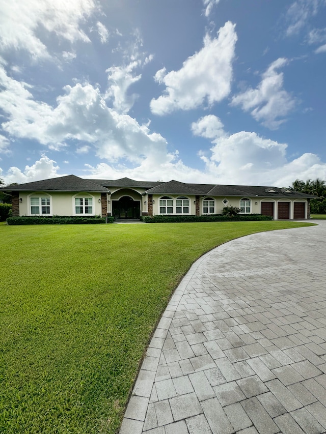 single story home with a front yard and a garage