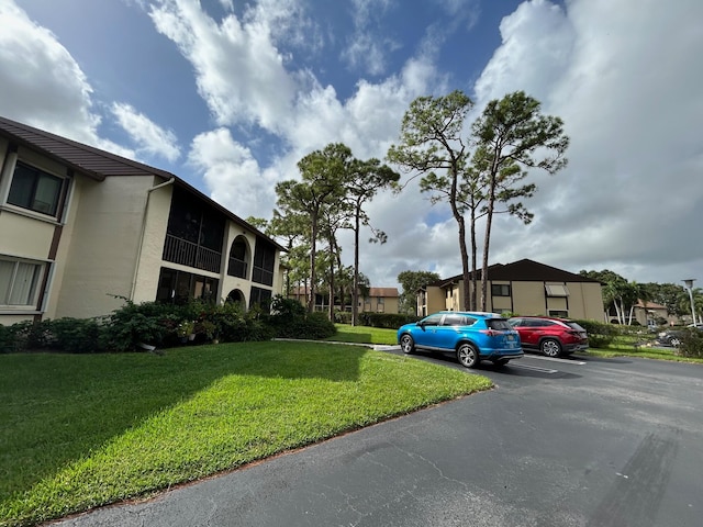 view of vehicle parking featuring a yard