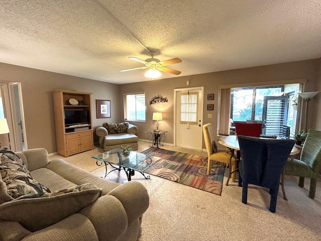 carpeted living room featuring a textured ceiling and ceiling fan