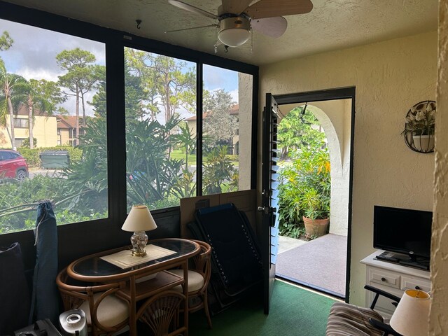 sunroom featuring ceiling fan