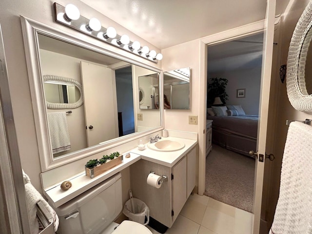 bathroom with tile patterned flooring, vanity, and toilet