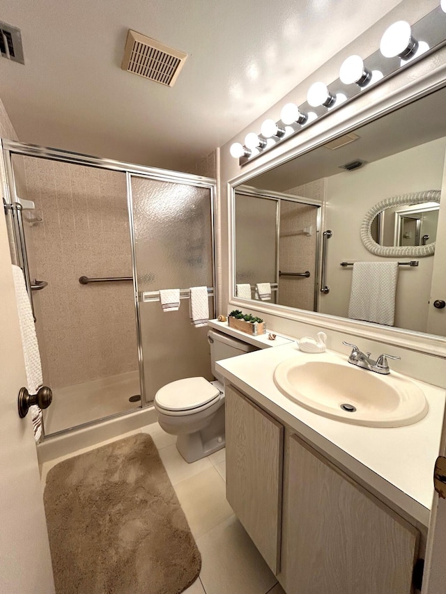 bathroom featuring tile patterned flooring, an enclosed shower, vanity, and toilet