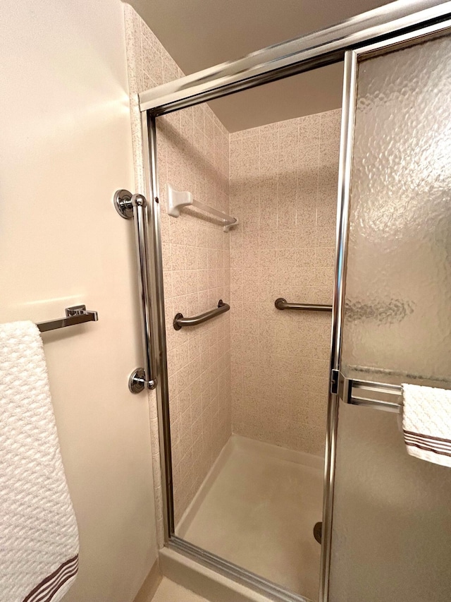 bathroom with a shower with door