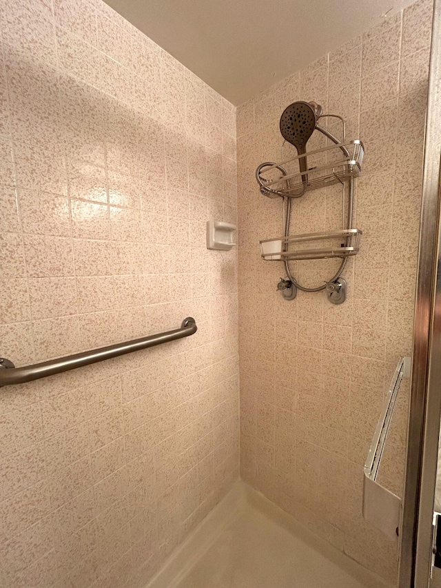 bathroom with tiled shower