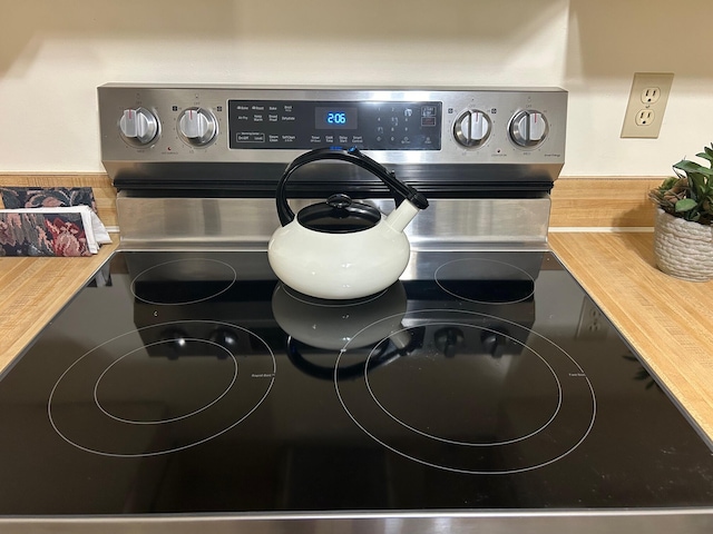 details featuring wooden counters and stainless steel electric range oven