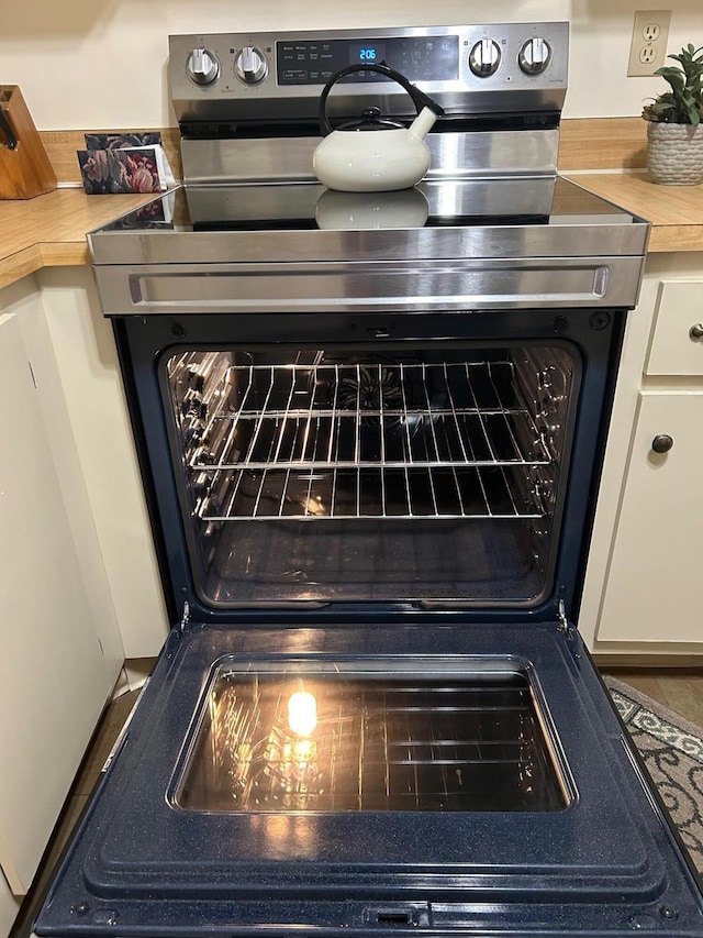 room details featuring butcher block countertops and electric range