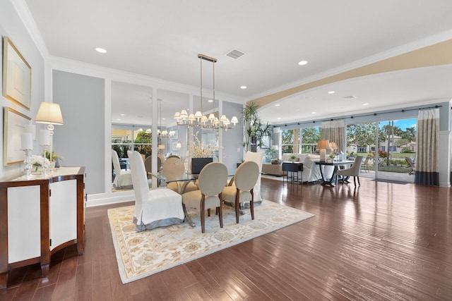 dining space with dark hardwood / wood-style flooring, a chandelier, and ornamental molding