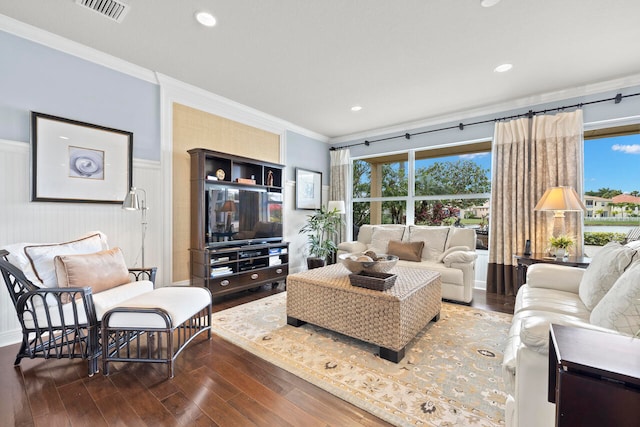 living room with ornamental molding, hardwood / wood-style floors, and a healthy amount of sunlight