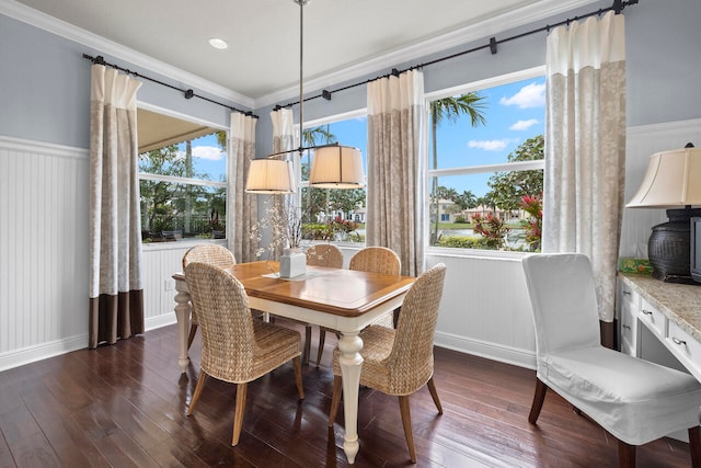 dining space featuring ornamental molding and dark hardwood / wood-style floors