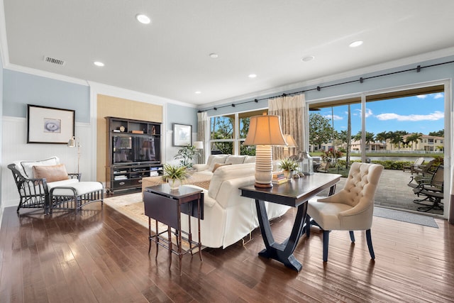 living room with dark wood-type flooring and ornamental molding