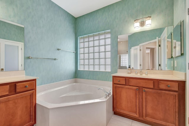 bathroom with vanity, a bath, and tile patterned flooring