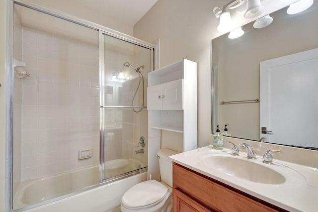 full bathroom with shower / bath combination with glass door, vanity, and toilet