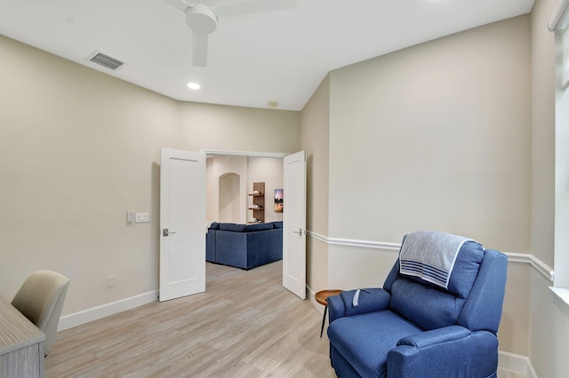 living area with light hardwood / wood-style flooring and ceiling fan