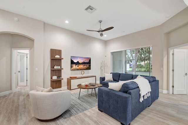 living room with light hardwood / wood-style flooring and ceiling fan