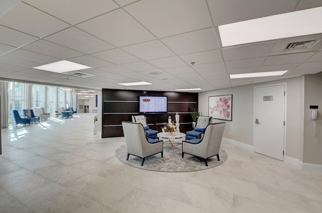 living room with a paneled ceiling