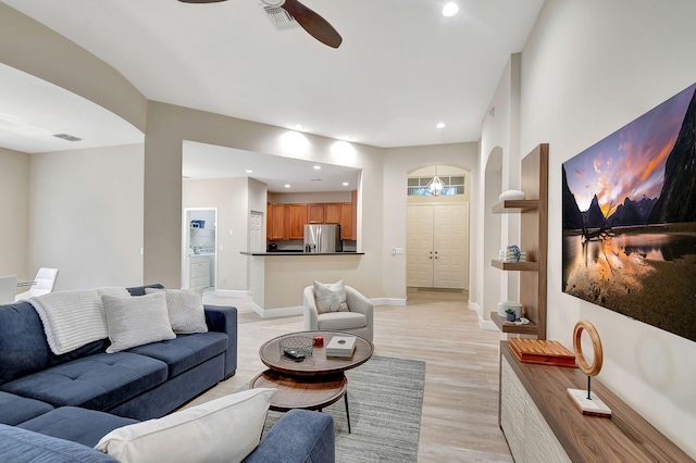 living room featuring light hardwood / wood-style flooring and ceiling fan