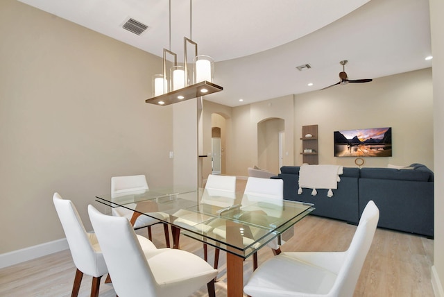 dining area with ceiling fan and light hardwood / wood-style floors