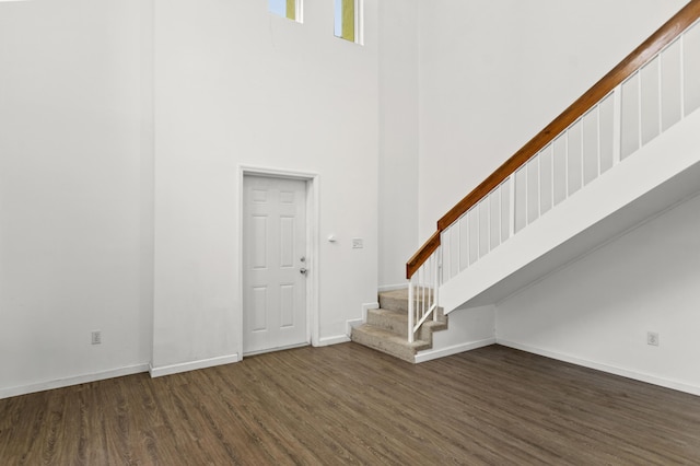 interior space featuring dark hardwood / wood-style flooring and a high ceiling