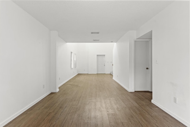 empty room with hardwood / wood-style floors