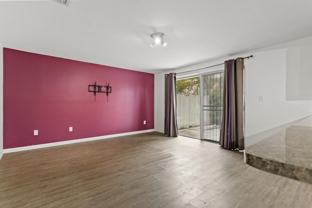 empty room with hardwood / wood-style floors