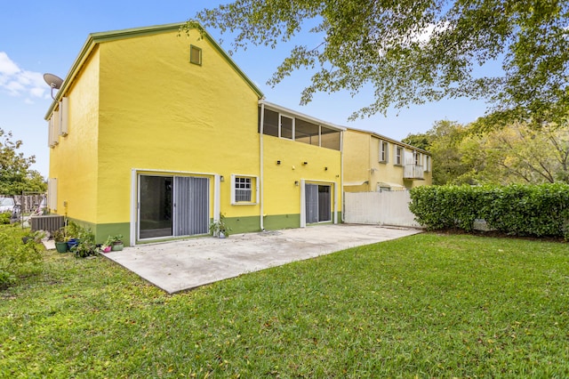 back of property featuring central air condition unit, a patio, and a lawn