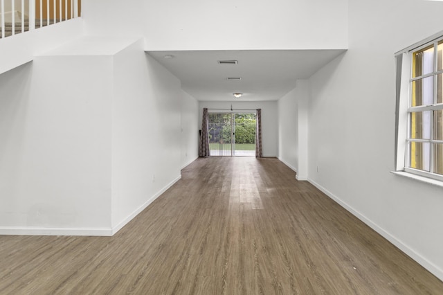 corridor with hardwood / wood-style flooring