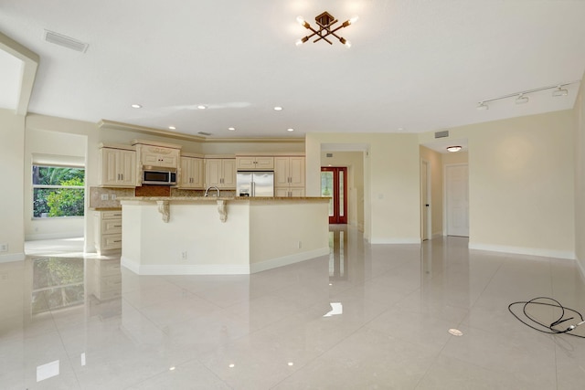 kitchen with stainless steel appliances, a breakfast bar, light stone counters, ornamental molding, and backsplash