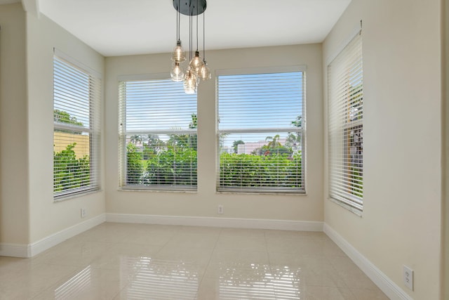 unfurnished room with light tile patterned floors and a notable chandelier