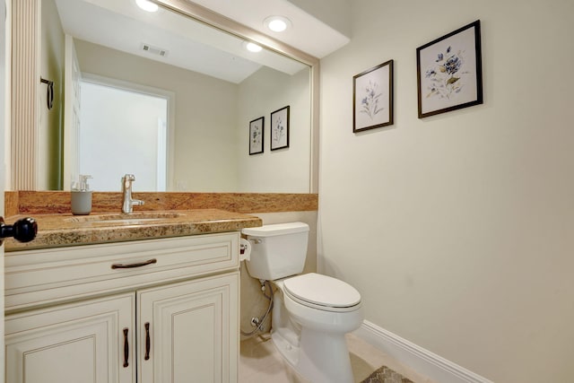 bathroom featuring tile patterned flooring, vanity, and toilet