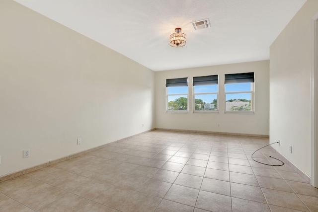 unfurnished room with light tile patterned flooring