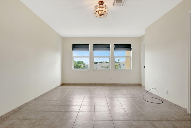 unfurnished room featuring light tile patterned flooring