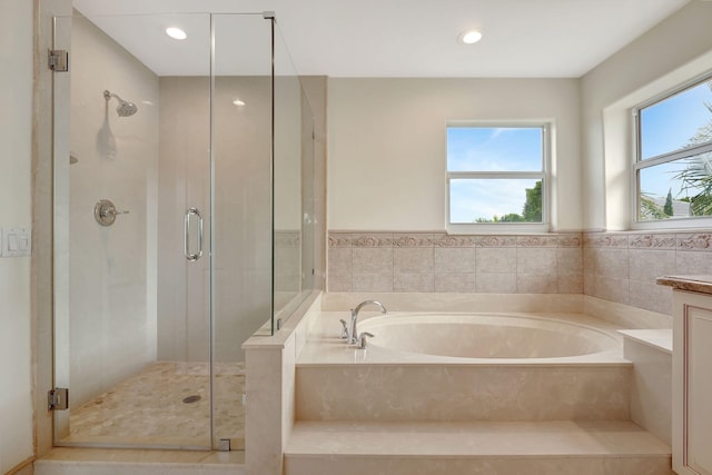 bathroom featuring shower with separate bathtub and vanity