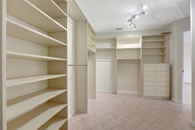 spacious closet featuring tile patterned floors