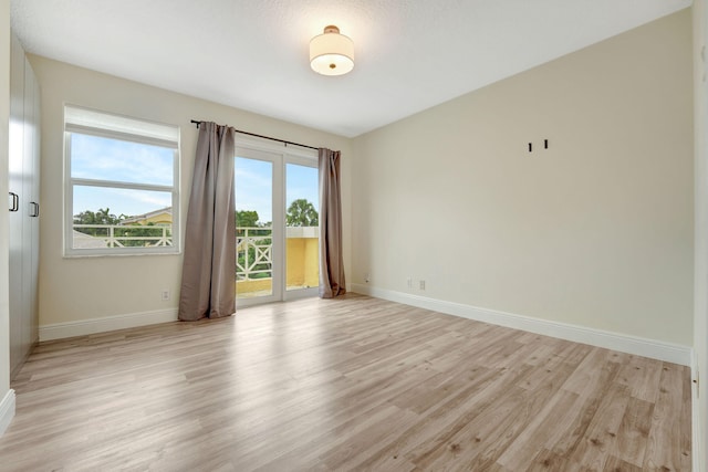 unfurnished room with light hardwood / wood-style floors