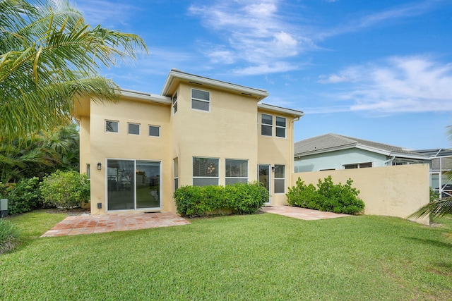 back of property with a patio area and a yard