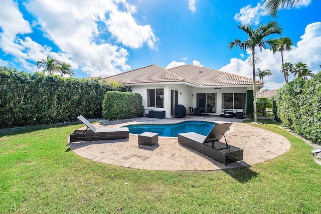 view of pool with a patio, an outdoor hangout area, and a yard