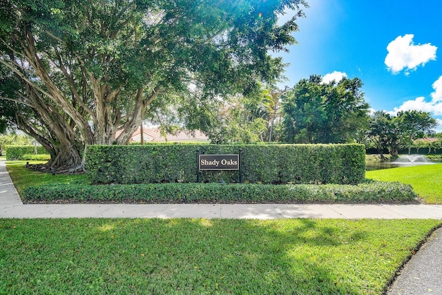 community / neighborhood sign with a water view