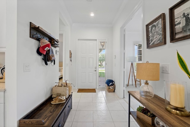 entrance foyer with light tile patterned flooring and crown molding