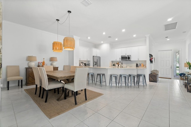 dining room featuring light tile patterned floors and crown molding