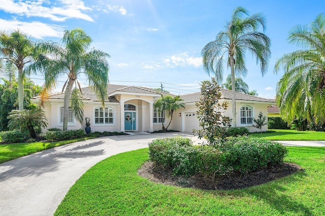 view of front of home featuring a garage and a front yard