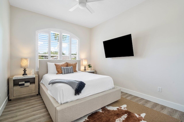 bedroom with light hardwood / wood-style floors and ceiling fan